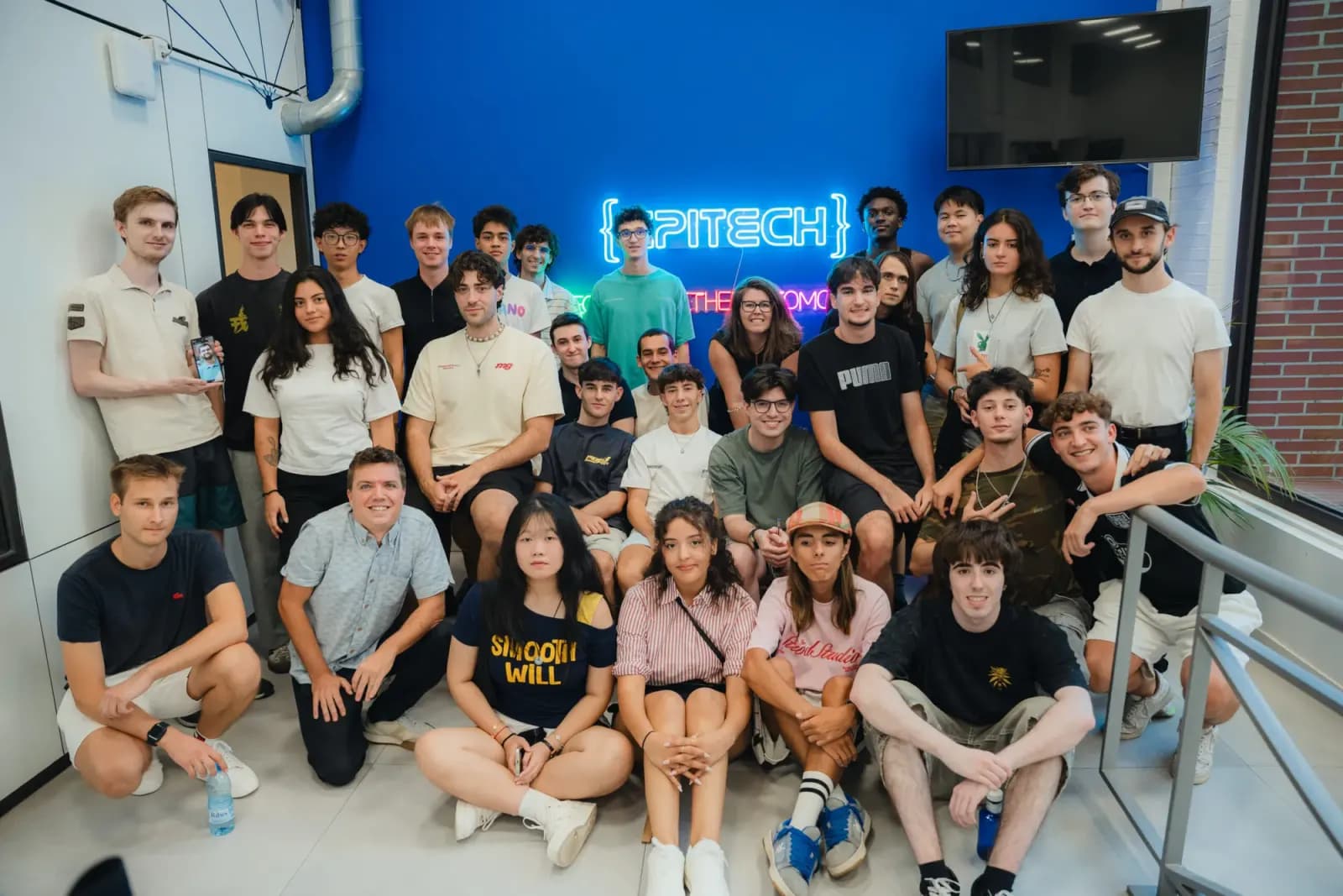 Estudiantes de primer curso de Epitech España durante la Welcome Week, frente al logo de Epitech